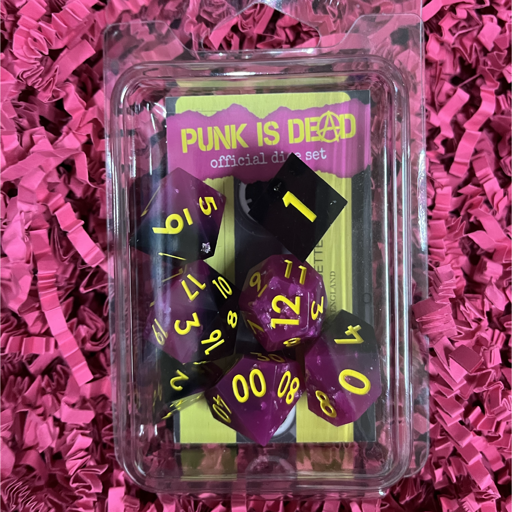 Punk Is Dead music role playing game dnd dice set, sharp edge dice in neon hot pink and black resin with yellow ink.